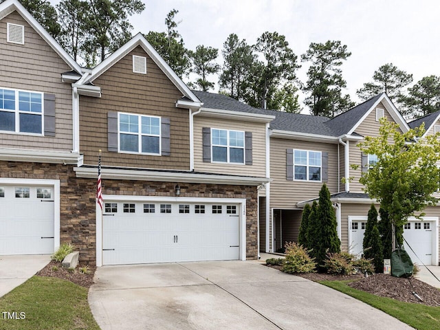 112 Churment Ct, Durham, NC 27703 - view of front of house featuring concrete driveway, an attached garage, and stone siding