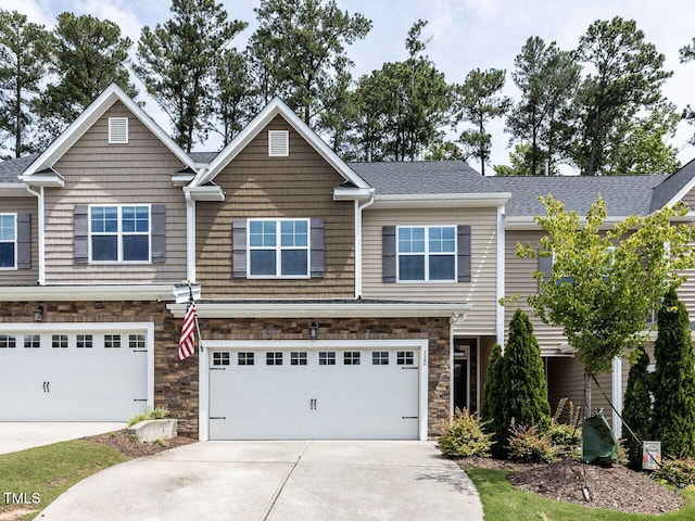 112 Churment Ct, Durham, NC 27703 - townhome / multi-family property with stone siding, concrete driveway, a garage, and roof with shingles