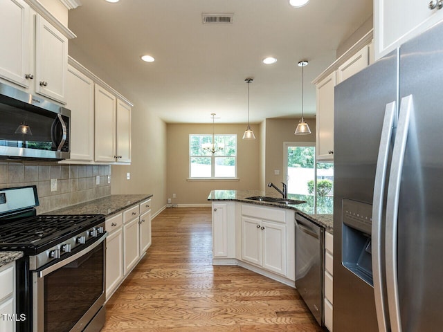 112 Churment Ct, Durham, NC 27703 - kitchen with appliances with stainless steel finishes, a peninsula, white cabinetry, and recessed lighting