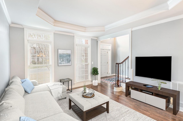 6020 Jones Farm Rd, Wake Forest, NC 27587 - living room with a tray ceiling, wood finished floors, crown molding, stairway, and baseboards