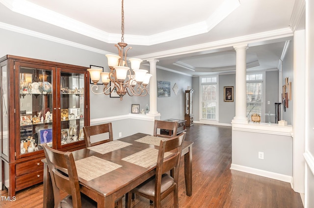 6020 Jones Farm Rd, Wake Forest, NC 27587 - dining space with a raised ceiling, wood finished floors, ornamental molding, ornate columns, and a chandelier