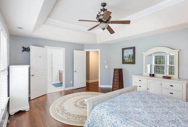 6020 Jones Farm Rd, Wake Forest, NC 27587 - bedroom featuring a raised ceiling, dark wood-style flooring, baseboards, ceiling fan, and ensuite bath
