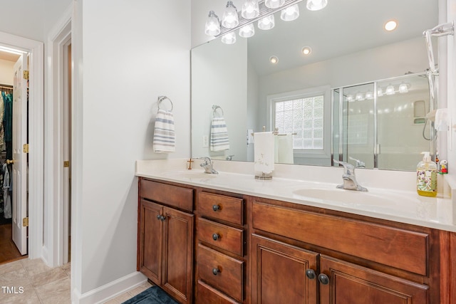 6020 Jones Farm Rd, Wake Forest, NC 27587 - bathroom featuring a shower stall, double vanity, a spacious closet, baseboards, and tile patterned flooring