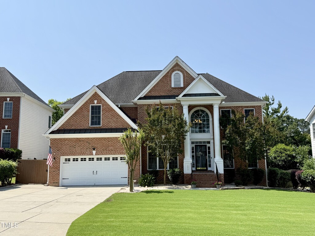 6020 Jones Farm Rd, Wake Forest, NC 27587 - neoclassical home featuring concrete driveway and brick siding