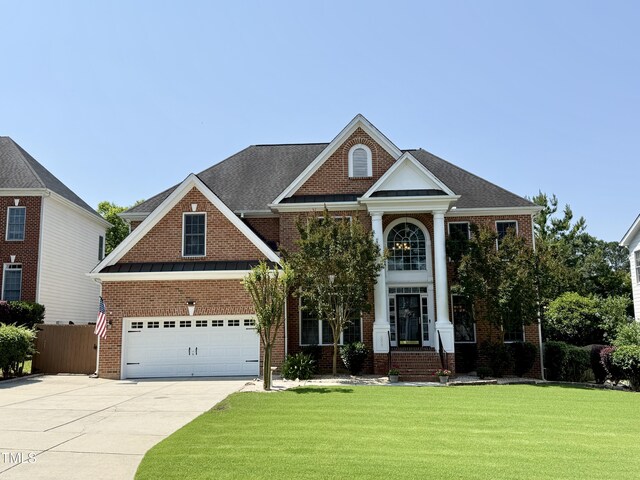 6020 Jones Farm Rd, Wake Forest, NC 27587 - neoclassical home featuring concrete driveway and brick siding