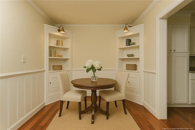 dining area featuring built in features, a decorative wall, and dark wood-type flooring