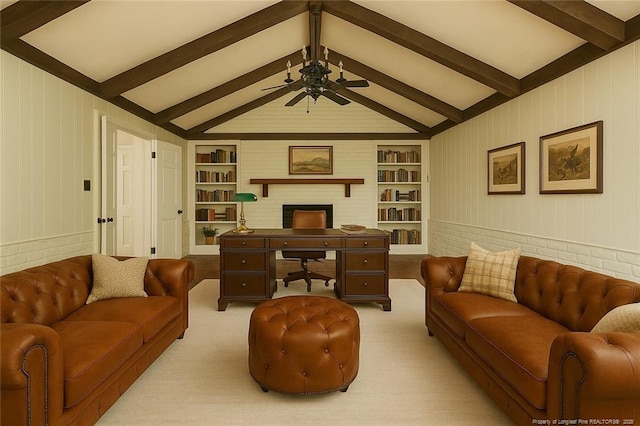carpeted living area with a brick fireplace, built in shelves, lofted ceiling with beams, and ceiling fan