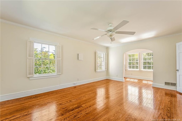 unfurnished room featuring visible vents, crown molding, ceiling fan, baseboards, and light wood-style floors