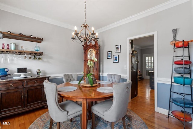 15 Longwood Dr, Youngsville, NC 27596 - dining room with wood finished floors, a chandelier, and crown molding