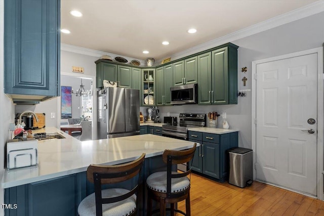 15 Longwood Dr, Youngsville, NC 27596 - kitchen with crown molding, a breakfast bar, light wood-style flooring, a peninsula, and appliances with stainless steel finishes