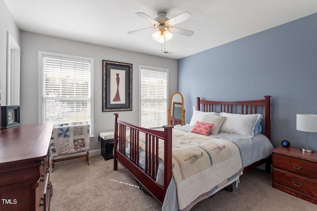 15 Longwood Dr, Youngsville, NC 27596 - bedroom with light colored carpet, a wood stove, baseboards, visible vents, and a ceiling fan