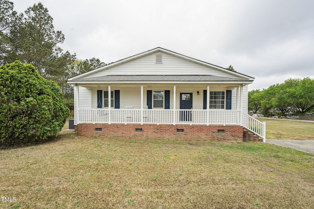 327F Bobbitt Rd, Clayton, NC 27520 - view of front facade featuring a shingled roof, a porch, and a front yard