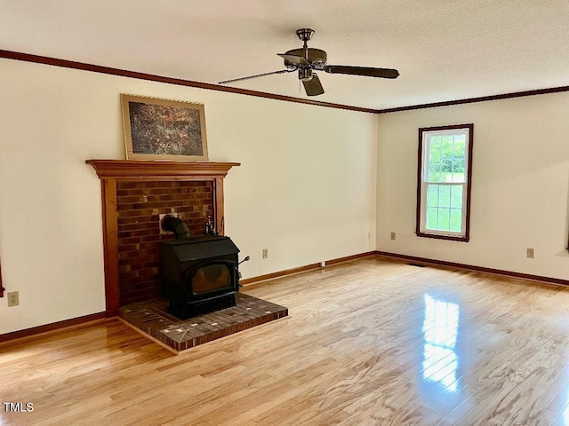 1401 Roy Averette Dr, Raleigh, NC 27603 - unfurnished living room with a wood stove, light wood finished floors, a ceiling fan, and crown molding