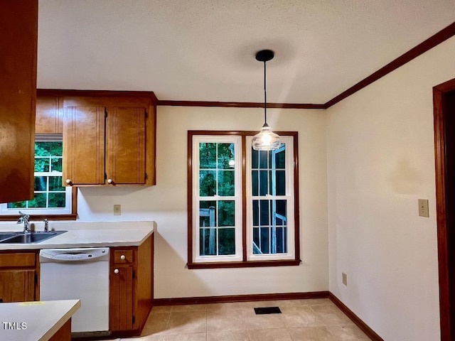 1401 Roy Averette Dr, Raleigh, NC 27603 - kitchen featuring dishwasher, brown cabinets, light countertops, pendant lighting, and ornamental molding