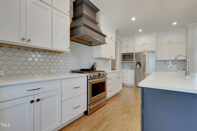 kitchen with decorative backsplash, high quality appliances, a sink, custom exhaust hood, and white cabinetry
