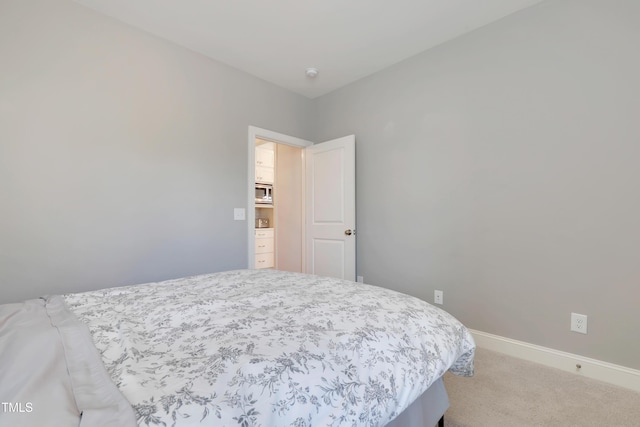 bedroom featuring carpet floors and baseboards