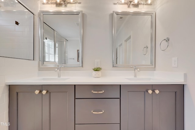 full bath featuring double vanity, walk in shower, and a sink