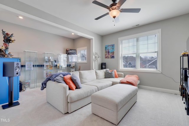 carpeted living area featuring a ceiling fan, baseboards, visible vents, and recessed lighting