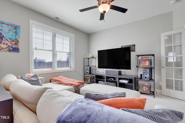 living room featuring a ceiling fan, carpet flooring, and visible vents