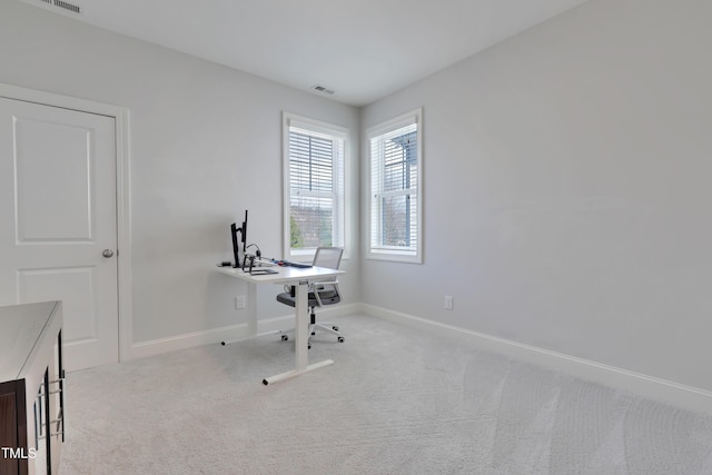 carpeted office featuring baseboards and visible vents