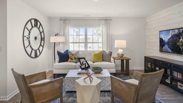 501 Ivory Ln, Goldsboro, NC 27534 - living room featuring baseboards, wood finished floors, and wood walls