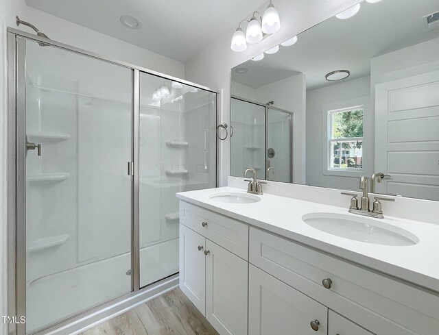 112 Remington Woods Dr, Wake Forest, NC 27587 - bathroom featuring a shower stall, wood finished floors, and double vanity