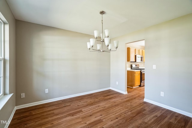 3316 Perkins Ridge Rd, Raleigh, NC 27610 - empty room featuring a chandelier, dark wood finished floors, and baseboards