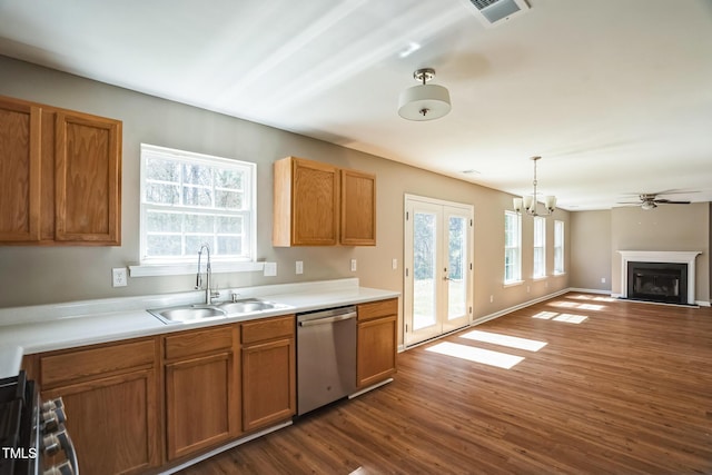 3316 Perkins Ridge Rd, Raleigh, NC 27610 - kitchen with appliances with stainless steel finishes, a sink, dark wood finished floors, a fireplace, and brown cabinets