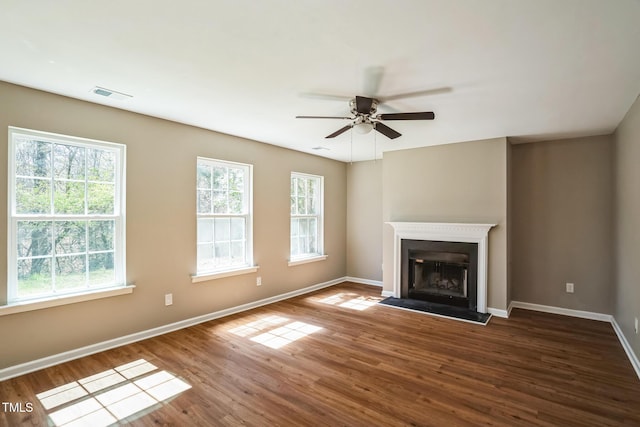 3316 Perkins Ridge Rd, Raleigh, NC 27610 - unfurnished living room featuring baseboards, wood finished floors, ceiling fan, and a fireplace