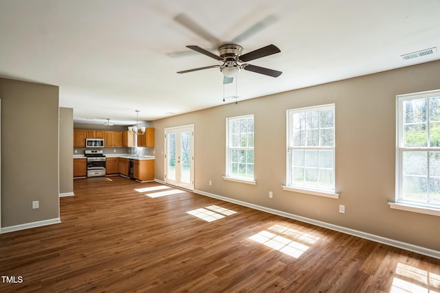 3316 Perkins Ridge Rd, Raleigh, NC 27610 - unfurnished living room featuring baseboards, dark wood finished floors, and plenty of natural light