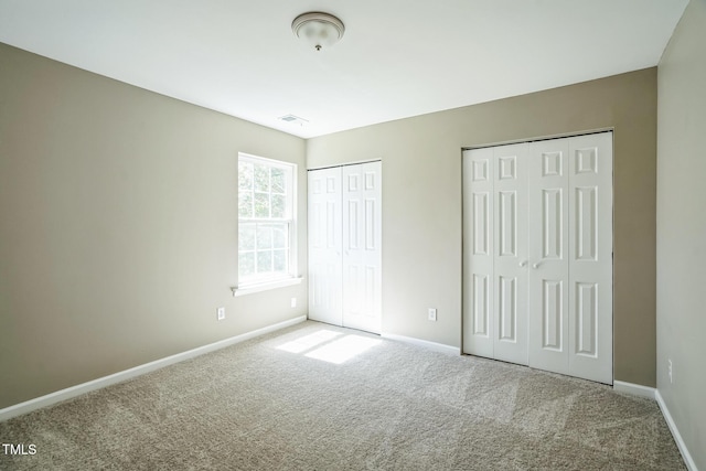 3316 Perkins Ridge Rd, Raleigh, NC 27610 - unfurnished bedroom with two closets, carpet floors, and baseboards