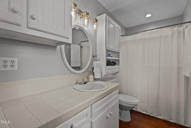 full bath featuring vanity, toilet, and wood finished floors