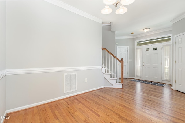 440 Heritage Village Ln, Apex, NC 27502 - entrance foyer featuring stairway, wood finished floors, crown molding, and a chandelier