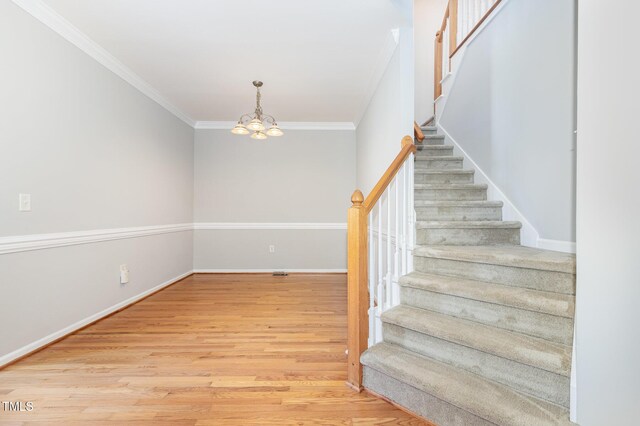 440 Heritage Village Ln, Apex, NC 27502 - stairs featuring a chandelier, wood finished floors, and crown molding