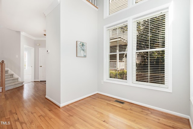 440 Heritage Village Ln, Apex, NC 27502 - unfurnished room with stairs, light wood-style floors, and crown molding