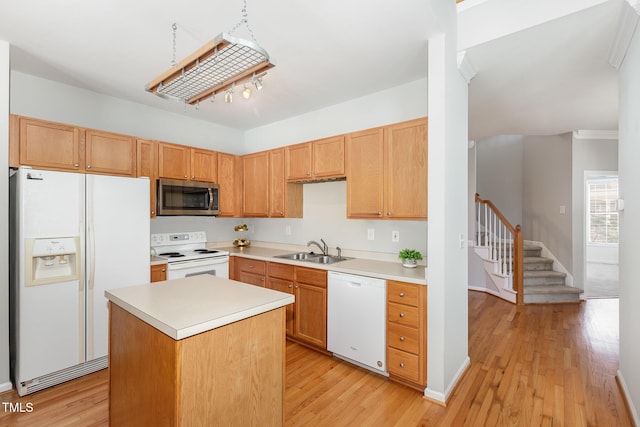 440 Heritage Village Ln, Apex, NC 27502 - kitchen featuring white appliances, light countertops, light wood-type flooring, and a kitchen island