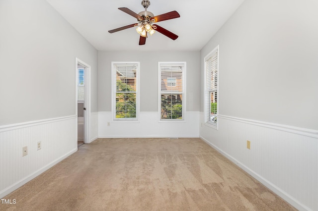 440 Heritage Village Ln, Apex, NC 27502 - carpeted empty room featuring a wainscoted wall and ceiling fan