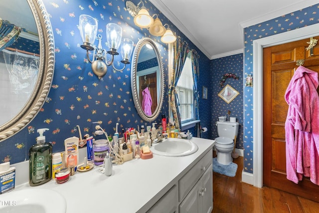 full bathroom with wallpapered walls, toilet, crown molding, and wood finished floors