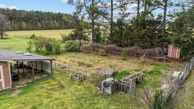 view of yard with a carport and fence