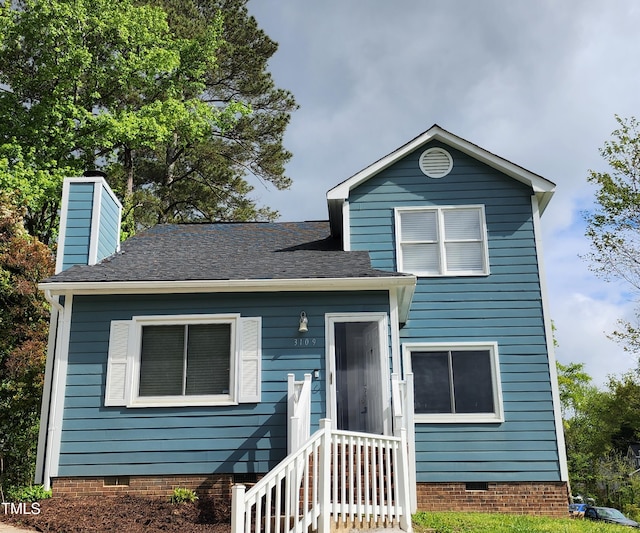 split level home with roof with shingles, a chimney, and crawl space