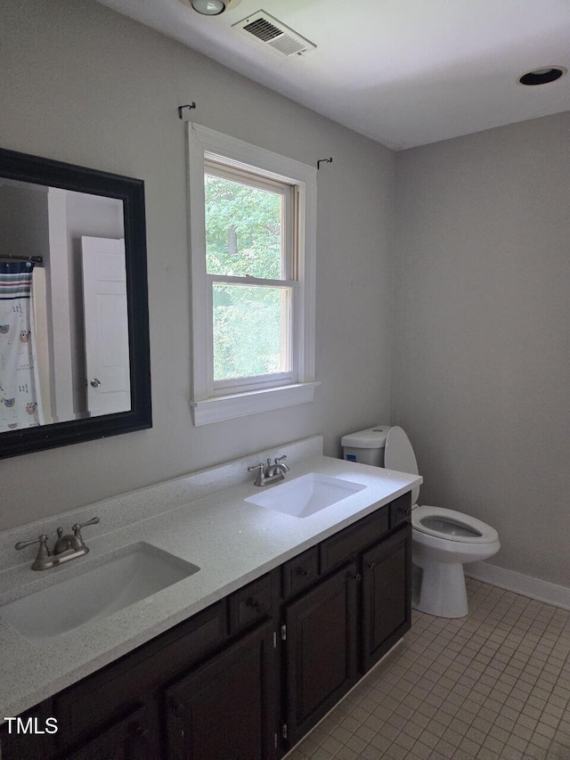 2000 Mountain Laurel Dr, Clayton, NC 27527 - bathroom with toilet, double vanity, and tile patterned floors