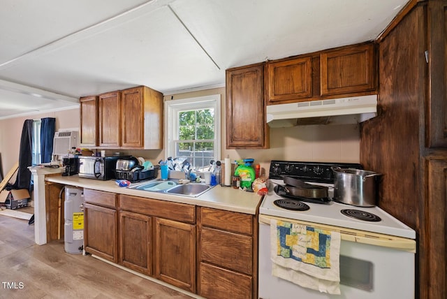 105 E Cole St, Dunn, NC 28334 - kitchen featuring white range with electric stovetop, under cabinet range hood, a sink, light countertops, and light wood-type flooring