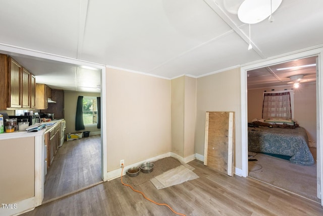 105 E Cole St, Dunn, NC 28334 - kitchen with light wood-style flooring, light countertops, brown cabinets, and baseboards