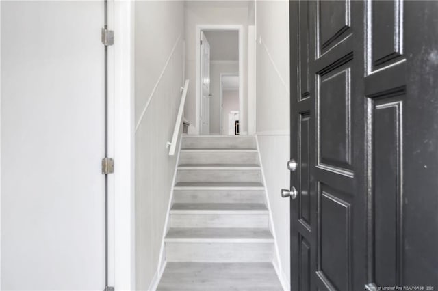stairway featuring wood finished floors