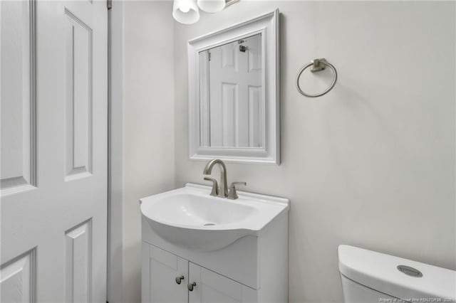 bathroom featuring toilet and vanity