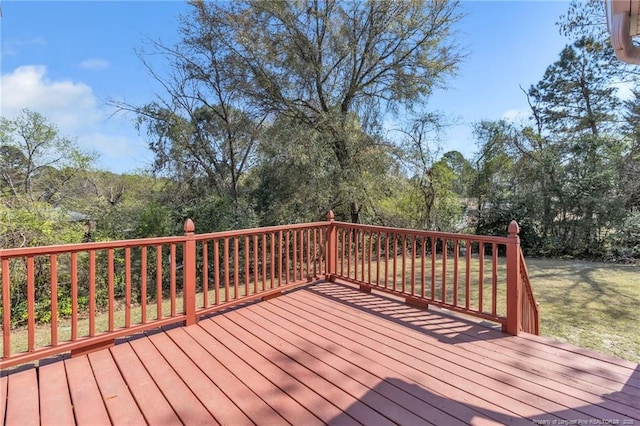 wooden terrace featuring a yard