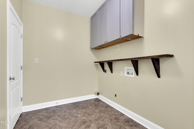clothes washing area featuring cabinet space, baseboards, and hookup for a washing machine