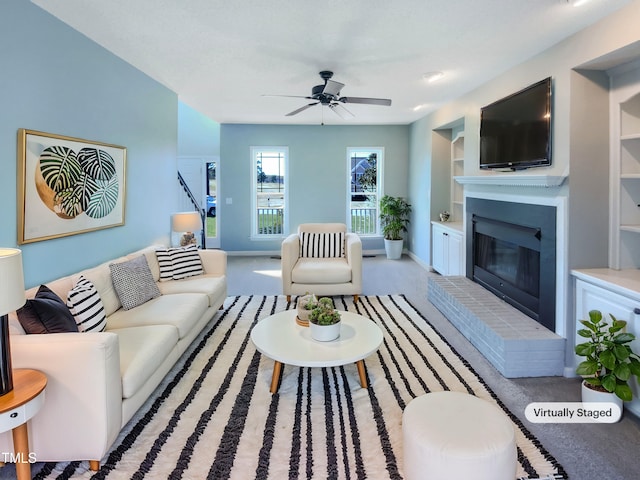 357 Riverwood Dr, Clayton, NC 27527 - carpeted living room with built in features, a ceiling fan, baseboards, and a brick fireplace