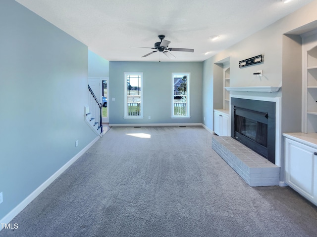 357 Riverwood Dr, Clayton, NC 27527 - unfurnished living room with a brick fireplace, baseboards, stairs, and built in shelves