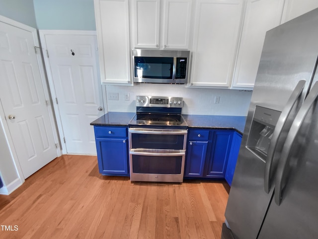 357 Riverwood Dr, Clayton, NC 27527 - kitchen with blue cabinets, stainless steel appliances, dark countertops, and light wood-type flooring